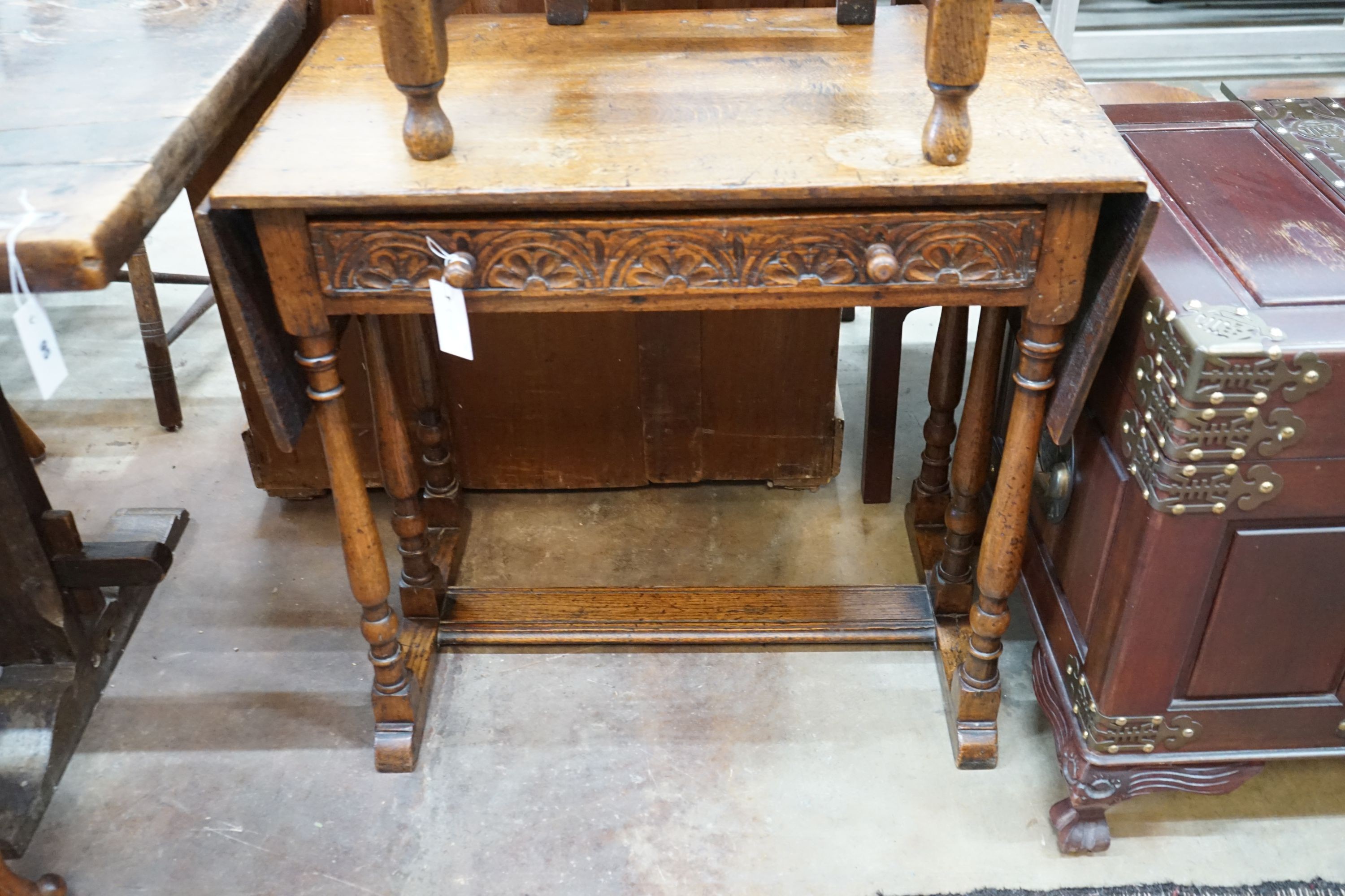 A 17th century style oak drop-leaf side table, width 79cm, depth 45cm, height 74cm together with a carved oak side chair
